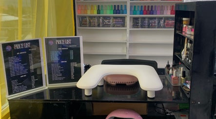 Nail station at Clawed by Chaoz in Greater Portmore, St. Catherine Parish, JM, featuring polish racks and price lists.