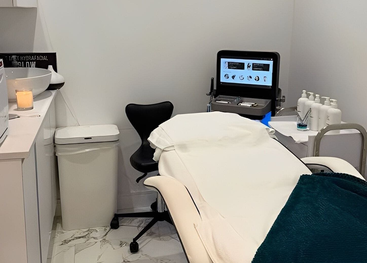 Glam Haus Clinic treatment room in Coventry, England, GB featuring a sleek bed and modern equipment.