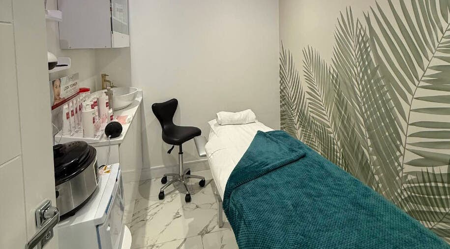 Spa treatment room at Glam Haus Clinic, Coventry, England, GB, featuring a cozy bed and calming decor.