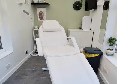 Bright treatment room at The Aesthetics Cabin, Newhaven, England, GB, featuring a modern white therapy chair.