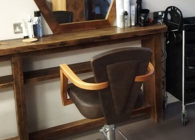Chic salon station at Hair by Aneta, Grimsby, England, GB, showcasing a rustic wooden styling area.