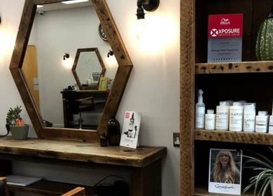 Stylish salon station at Hair by Aneta in Grimsby, England, GB, featuring a rustic mirror and quality products.
