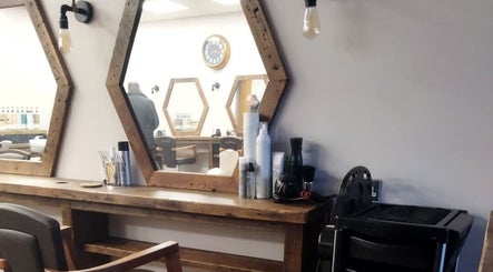 Stylish hair salon interior at Hair by Aneta with hexagonal mirrors in Grimsby, England, GB.