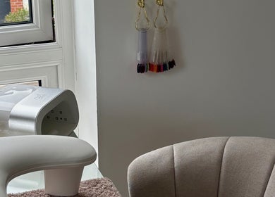 Elegant nail station at CLN Cosmetics, Newport, Wales, GB, showcasing a cozy setup and nail color display.