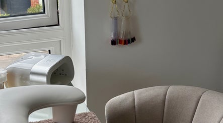 Elegant nail station at CLN Cosmetics, Newport, Wales, GB, showcasing a cozy setup and nail color display.