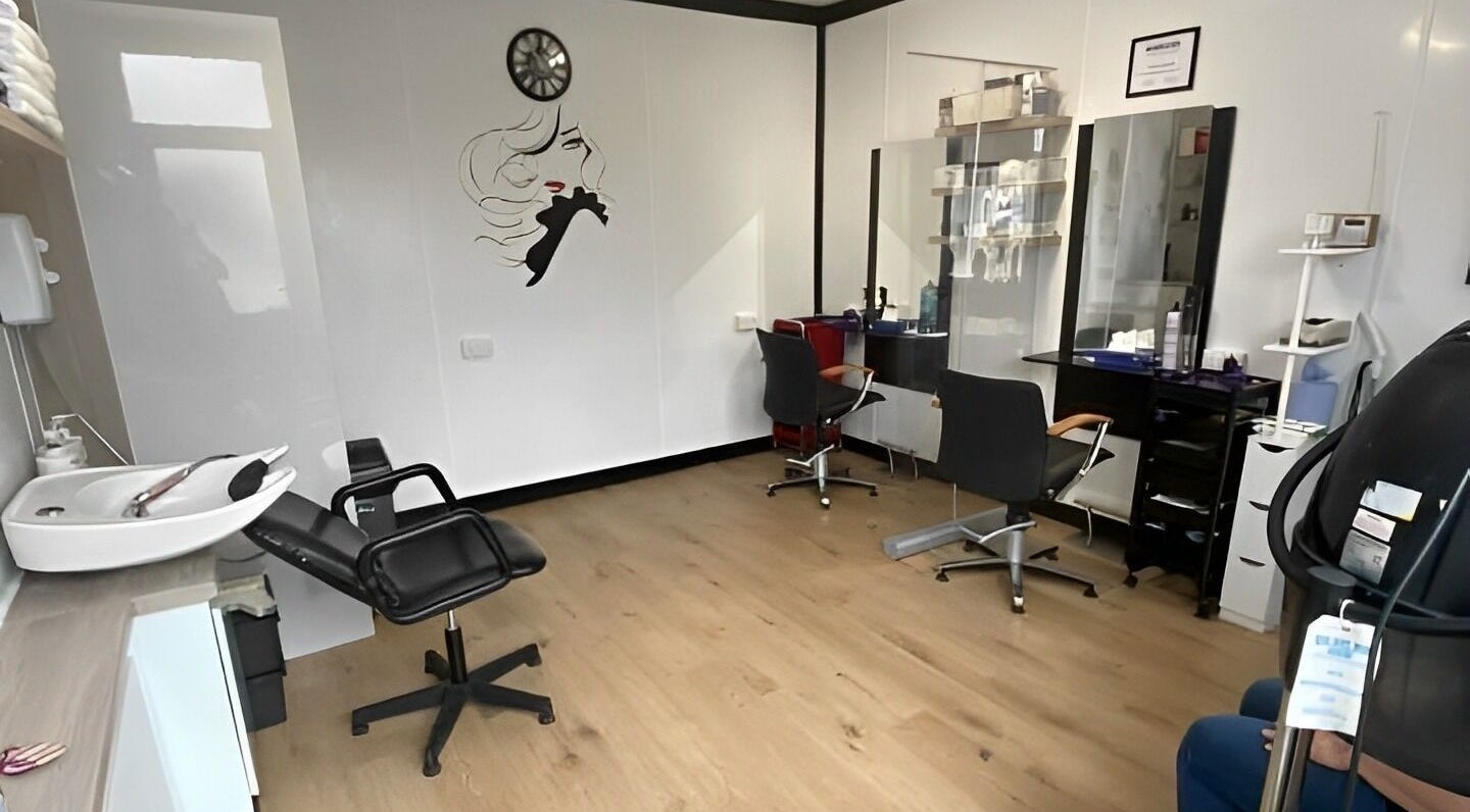Modern styling chairs and wash station at Cameo Hair Salon in Bagshot, England, GB.