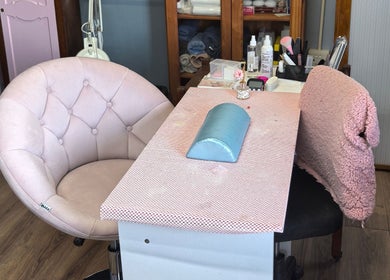 Chic nail station at El Shaddai Beauty Bar, Cape Town, Western Cape, ZA, featuring plush seating and beauty tools.