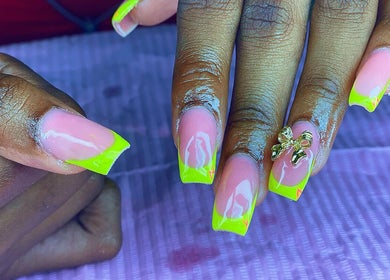 Bright neon yellow nails with bow accent at Vivid Nails Studio, St. Michael, Saint James, BB.