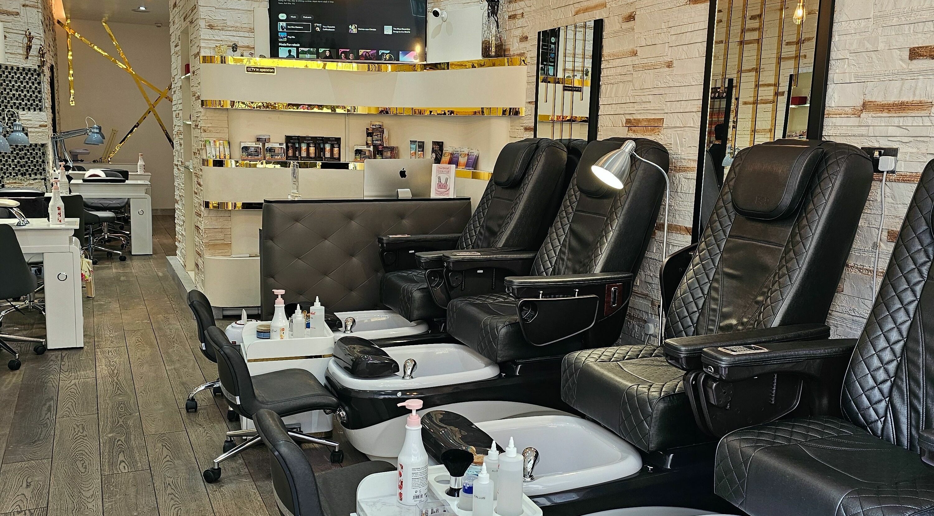 Luxurious interior of M D Nails & Beauty in London, England. Comfortable pedicure chairs and stylish decor.