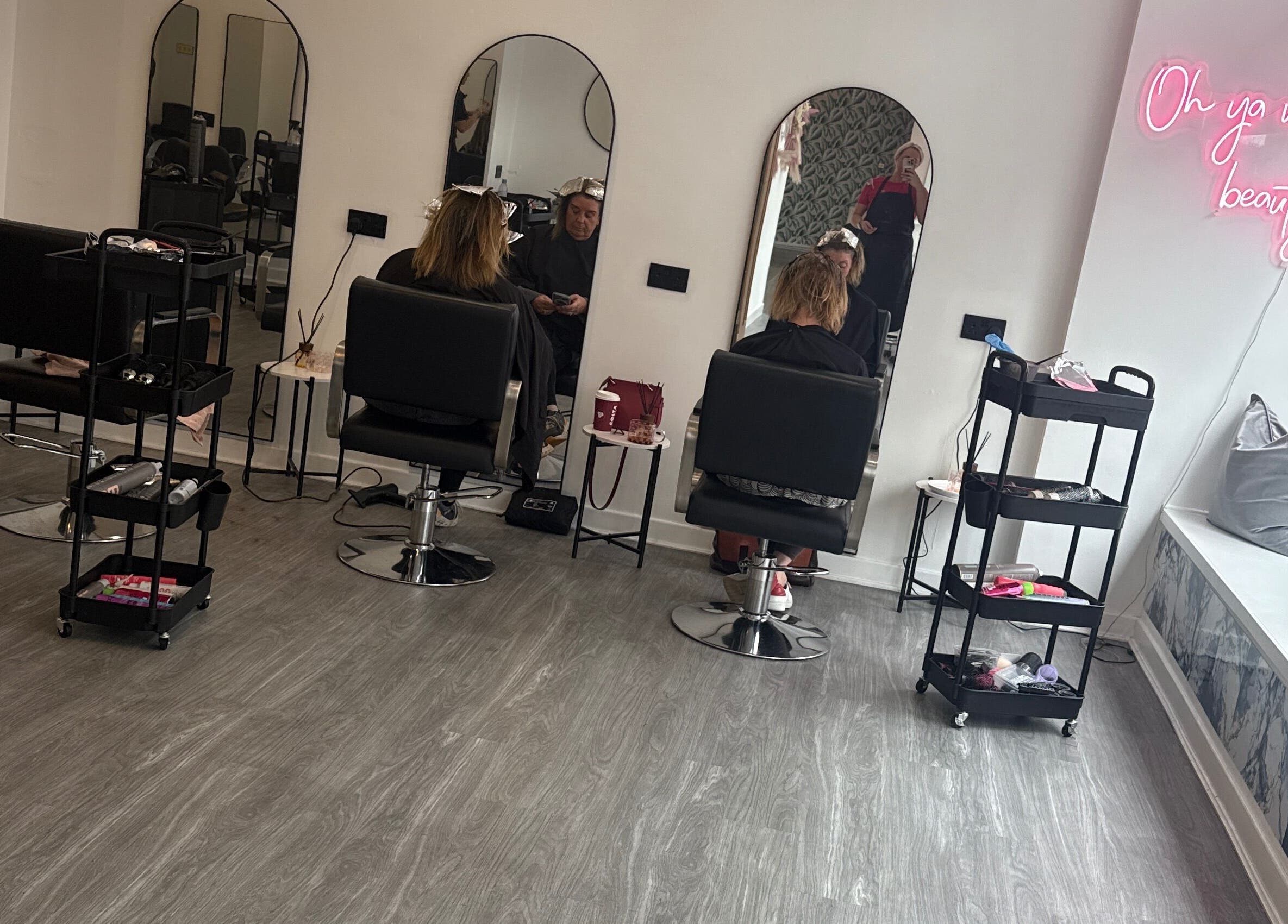 Modern salon chairs and mirrors at Robyn Ashley Hair & Beauty, Glasgow, Scotland, GB, showcasing stylish beauty services.