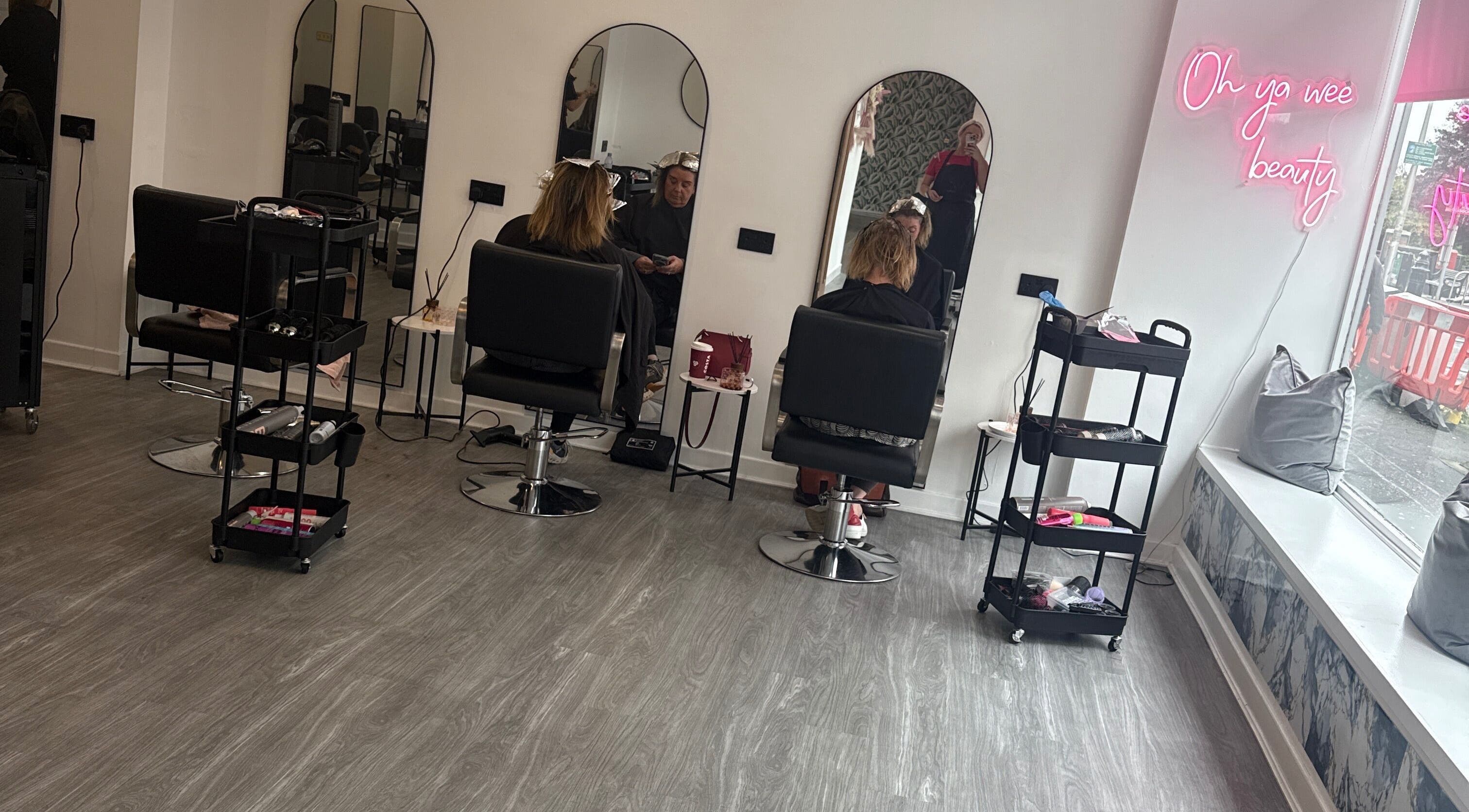 Modern salon chairs and mirrors at Robyn Ashley Hair & Beauty, Glasgow, Scotland, GB, showcasing stylish beauty services.