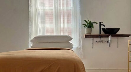 Cozy treatment room at Facial Healing Co. Armadale, Melbourne, Victoria, AU with soft bedding and warm decor.