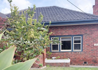 Charming brick facade of Facial Healing Co. nestled in lush greenery at Ormond, Victoria, AU.