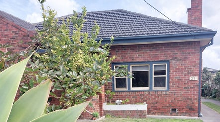 Charming brick facade of Facial Healing Co. nestled in lush greenery at Ormond, Victoria, AU.
