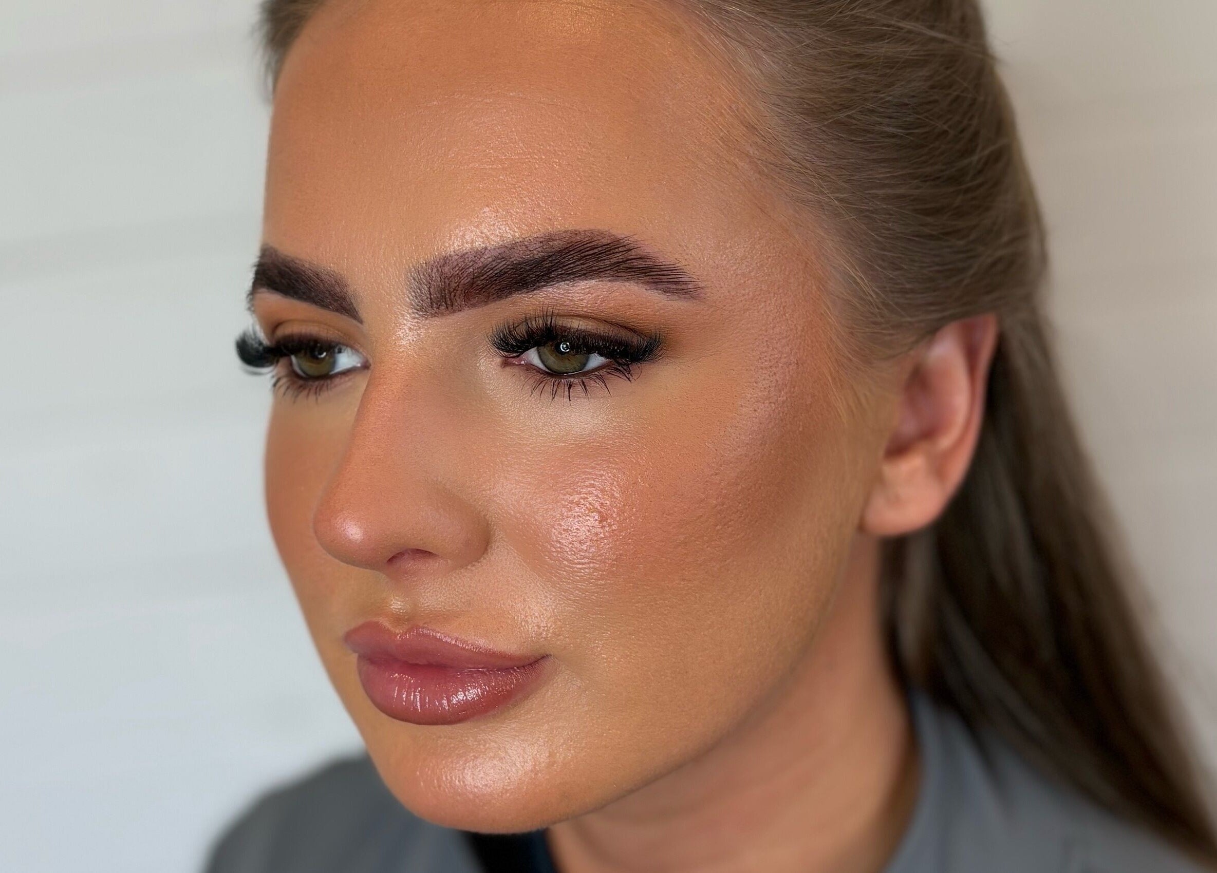 Close-up of makeup by Lucy, showcasing flawless skin and bold brows in Dundee, Scotland, GB.