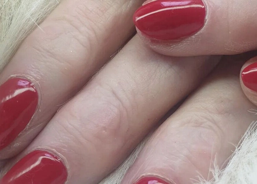 Close-up of manicured nails with red polish at OM Nail Design, Dublin, County Dublin, IE.