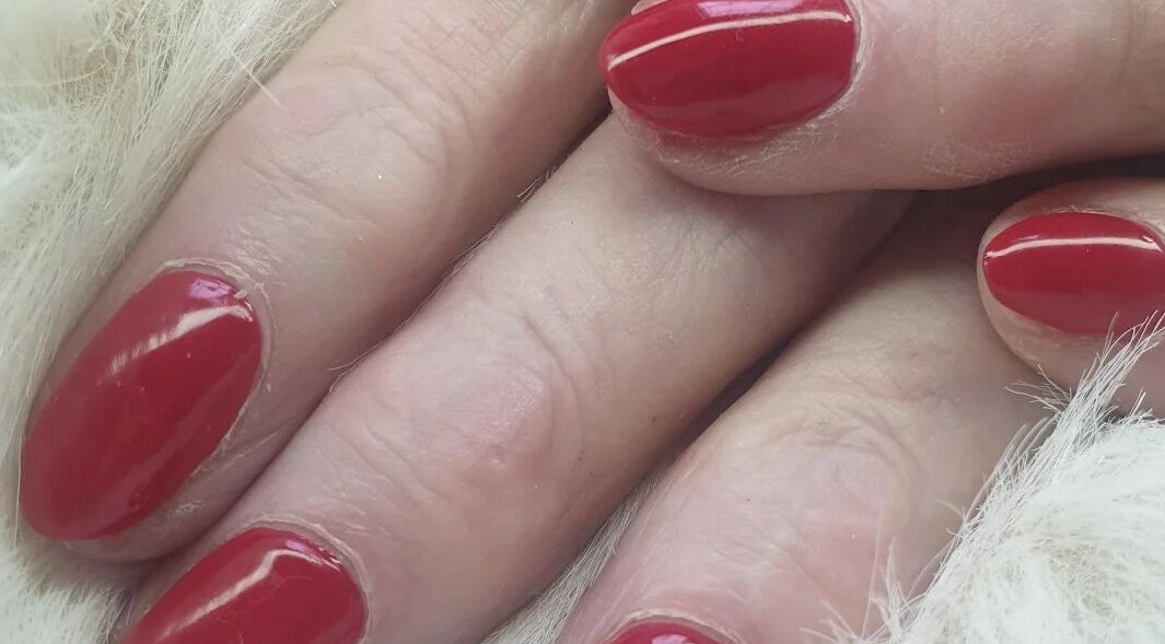 Close-up of manicured nails with red polish at OM Nail Design, Dublin, County Dublin, IE.