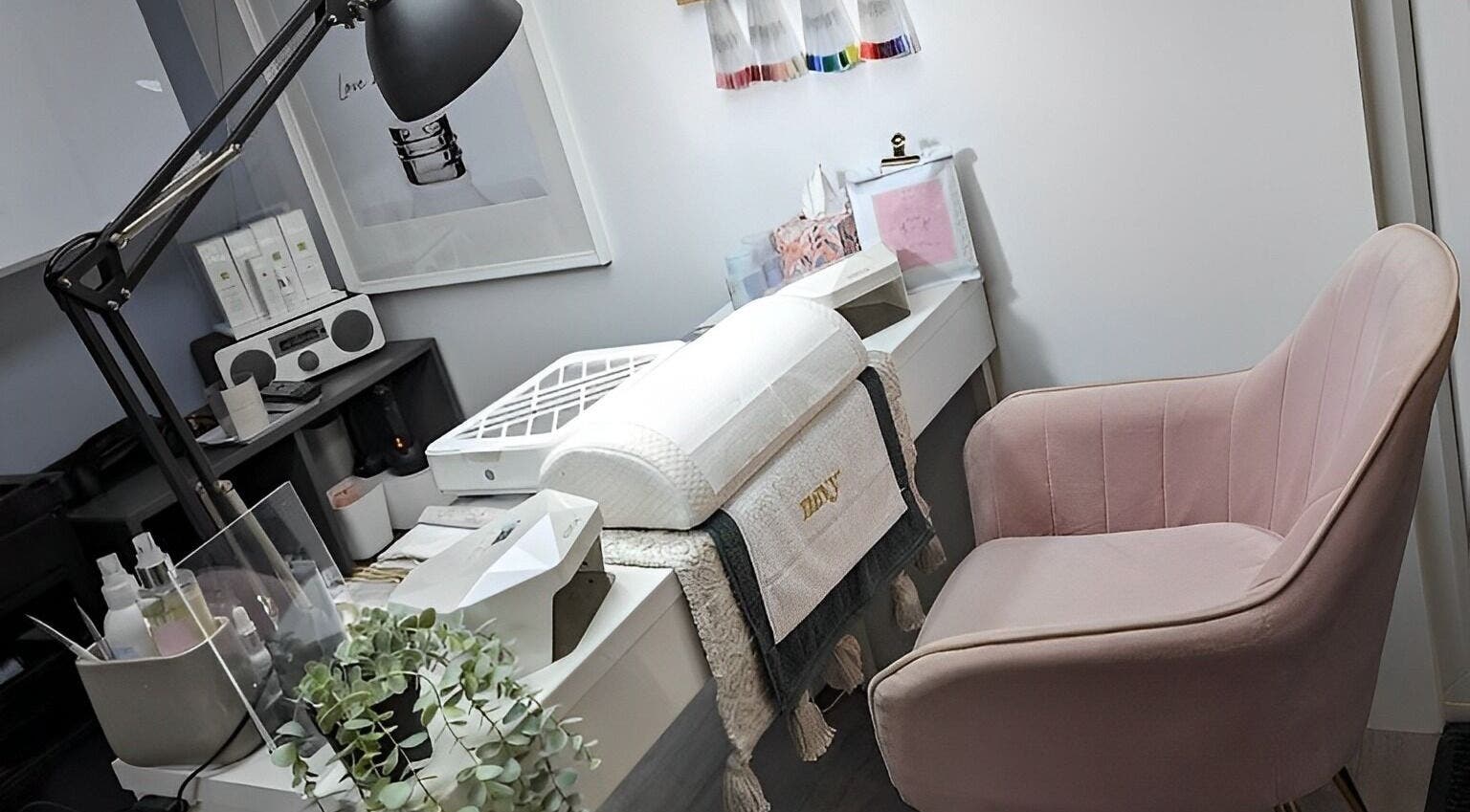 Modern beauty station at Luna Blush, Highworth, England, GB with pink chair and stylish decor.