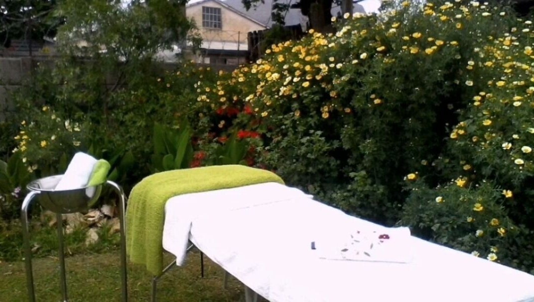 Tranquil outdoor massage setup at Wolseley Mobile MediSpa, Wolseley, Western Cape, ZA, surrounded by vibrant flowers.