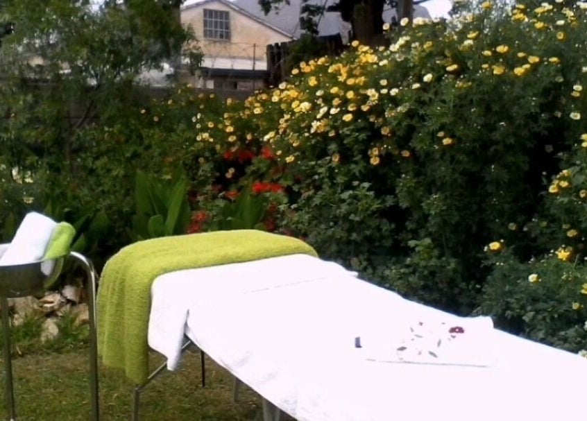 Tranquil outdoor massage setup at Wolseley Mobile MediSpa, Wolseley, Western Cape, ZA, surrounded by vibrant flowers.