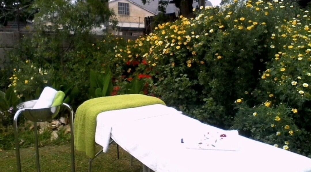 Tranquil outdoor massage setup at Wolseley Mobile MediSpa, Wolseley, Western Cape, ZA, surrounded by vibrant flowers.