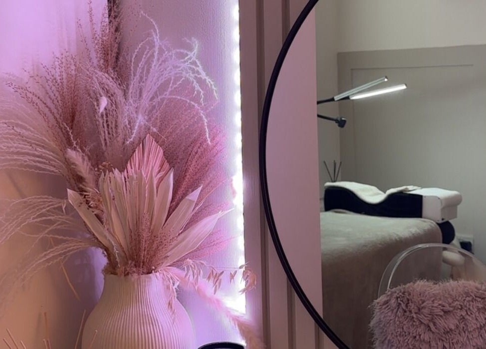 Elegant decor at The Aura Cabin, Bobbing, England, GB, featuring pastel floral arrangements and a cozy treatment chair.