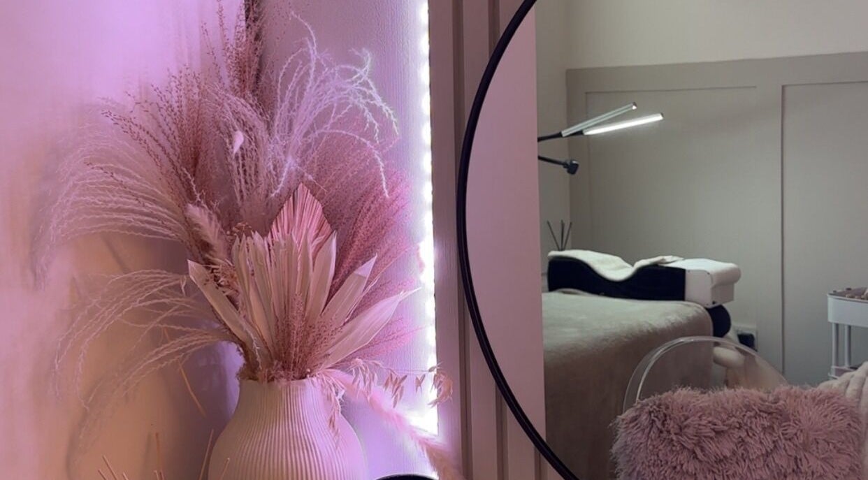 Elegant decor at The Aura Cabin, Bobbing, England, GB, featuring pastel floral arrangements and a cozy treatment chair.