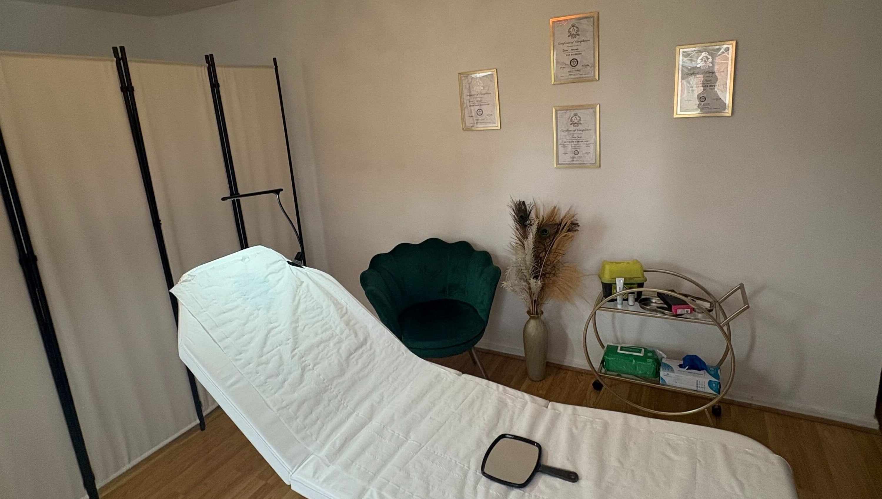 Tranquil treatment room at Revive Aesthetic Lab, London, England, GB, with a plush chair and diplomas.