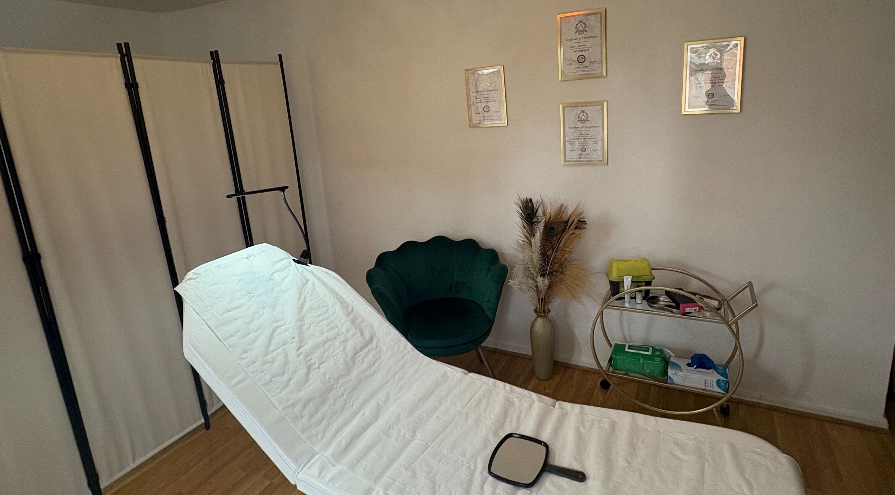 Tranquil treatment room at Revive Aesthetic Lab, London, England, GB, with a plush chair and diplomas.