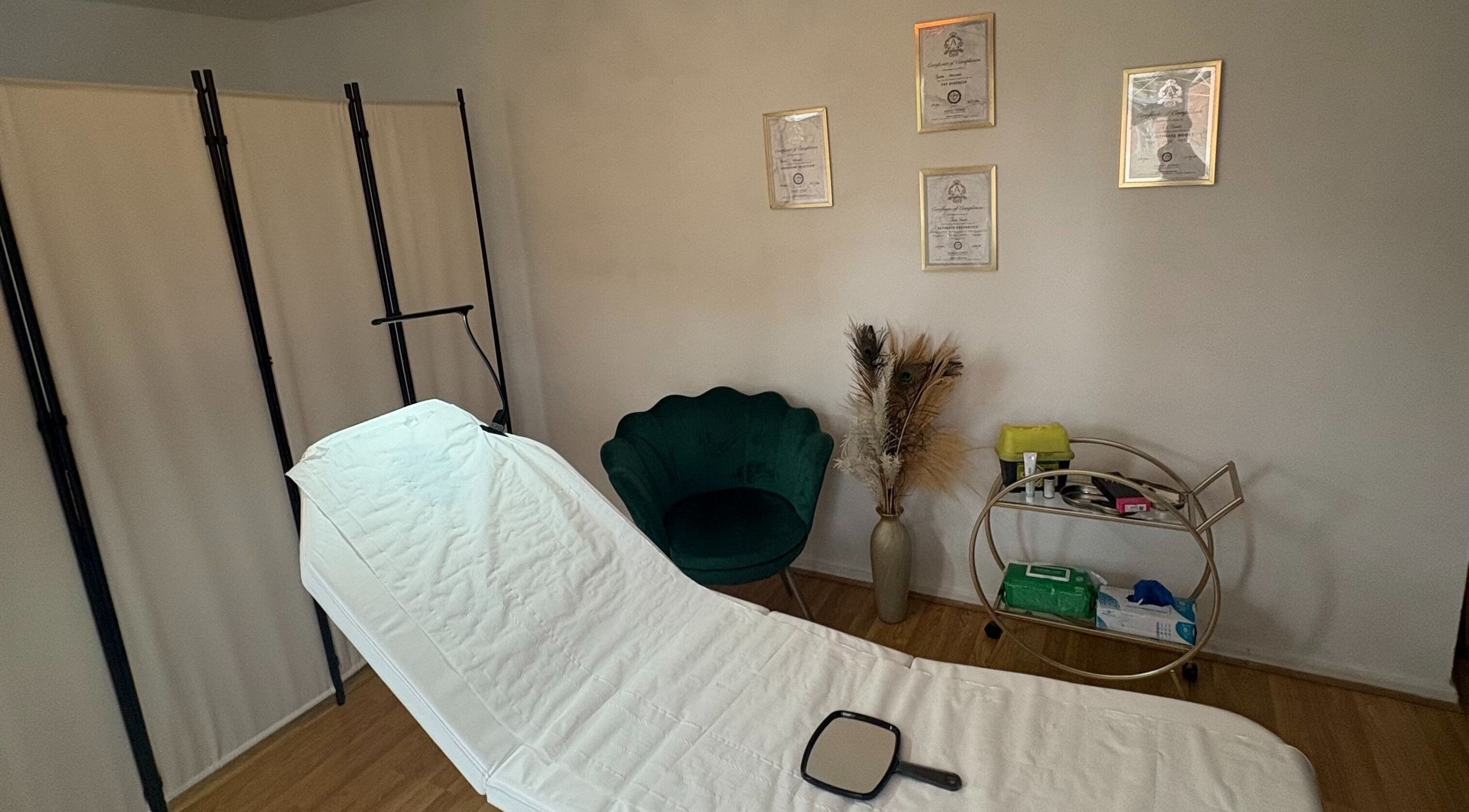 Tranquil treatment room at Revive Aesthetic Lab, London, England, GB, with a plush chair and diplomas.