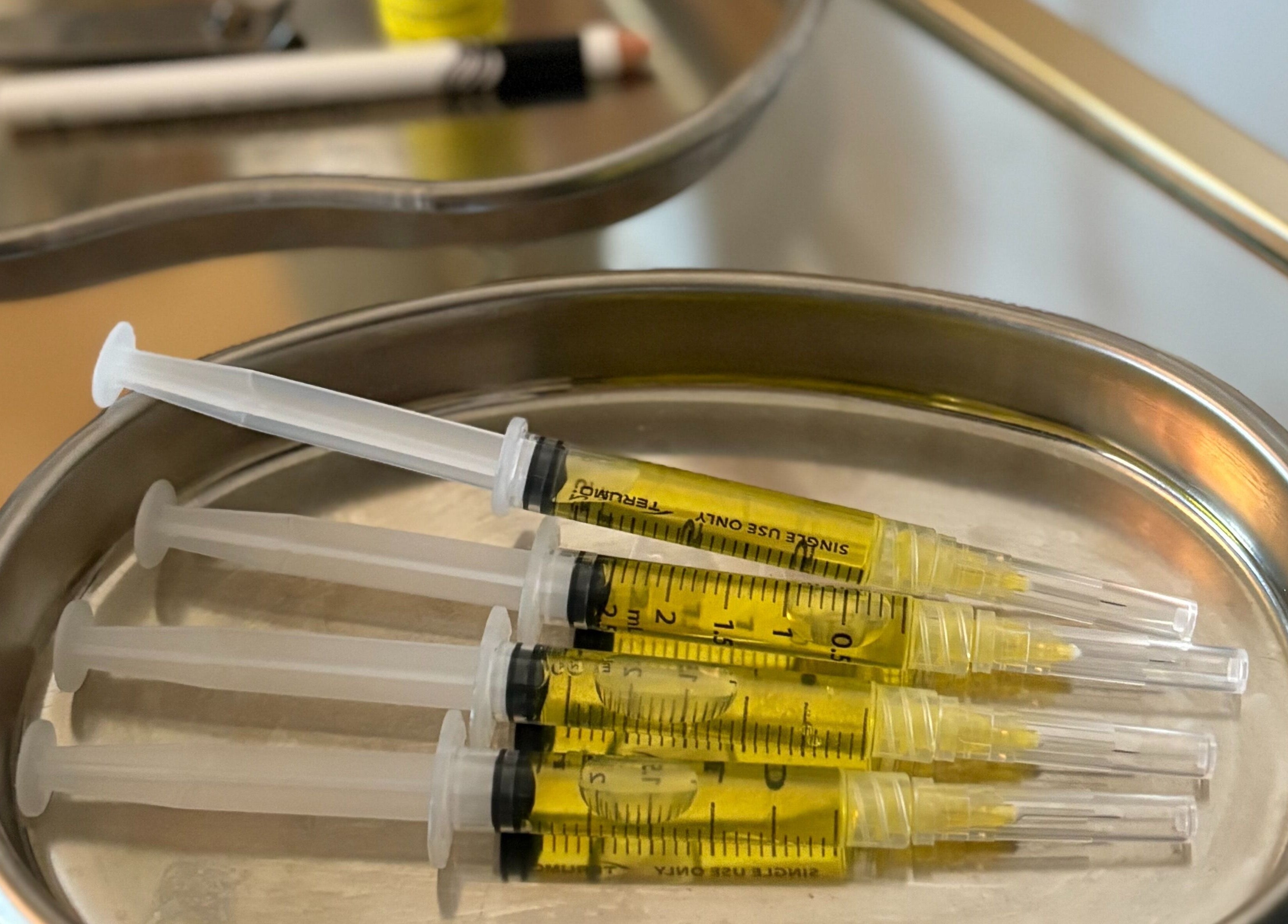 Injectable serums on a tray at Revive Aesthetic Lab, London, England, GB, showcasing advanced skincare.