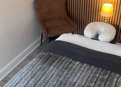 Relaxing therapy room at Woodview Holistic Therapies in Sheffield, England, GB with massage bed and warm lighting.