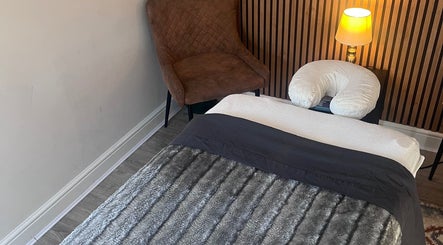 Relaxing therapy room at Woodview Holistic Therapies in Sheffield, England, GB with massage bed and warm lighting.