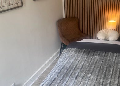 Tranquil therapy room at Woodview Holistic Therapies in Sheffield, England, GB with plush bed and soft lighting.