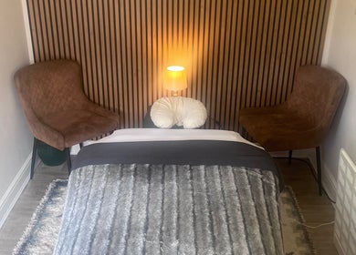 Relaxing therapy room at Woodview Holistic Therapies, Sheffield, England, GB with cozy decor and chairs.