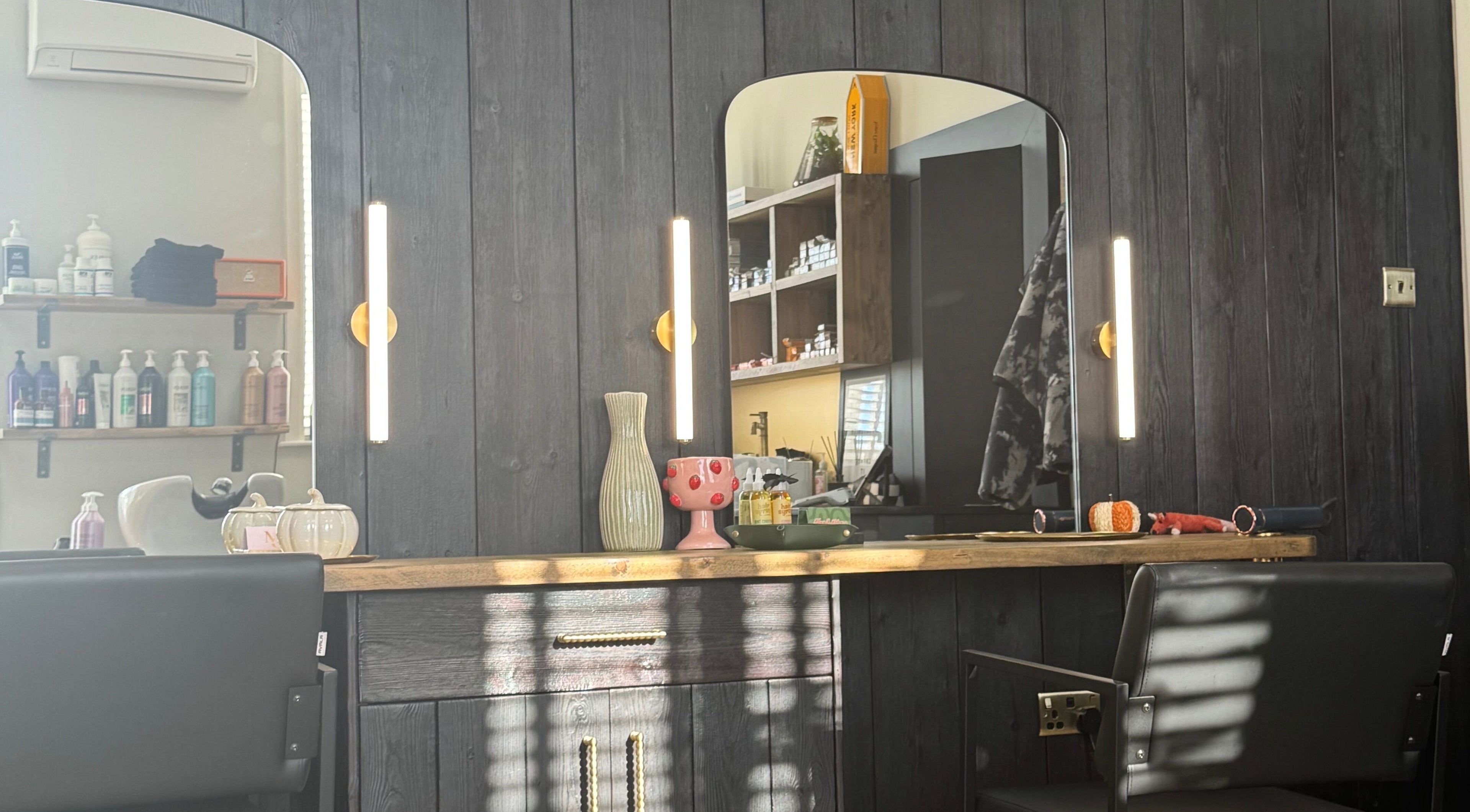 Elegant hair salon station at Fox & Muse Hair Room, Newmarket, England, GB with stylish decor and modern mirrors.