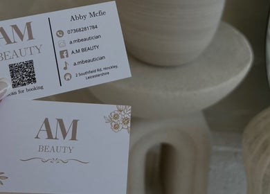 A.M Beauty business cards in Hinckley, England, GB featuring contact details and floral design.