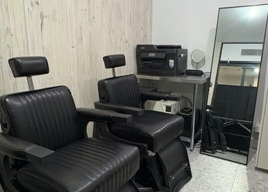Chic black salon chairs at Ouchie, Manly, New South Wales, AU offering modern beauty services.