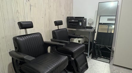 Chic black salon chairs at Ouchie, Manly, New South Wales, AU offering modern beauty services.