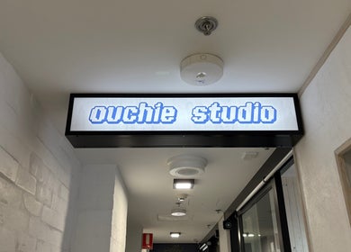 Ouchie studio entrance sign in Manly, New South Wales, AU showcases modern and inviting design.