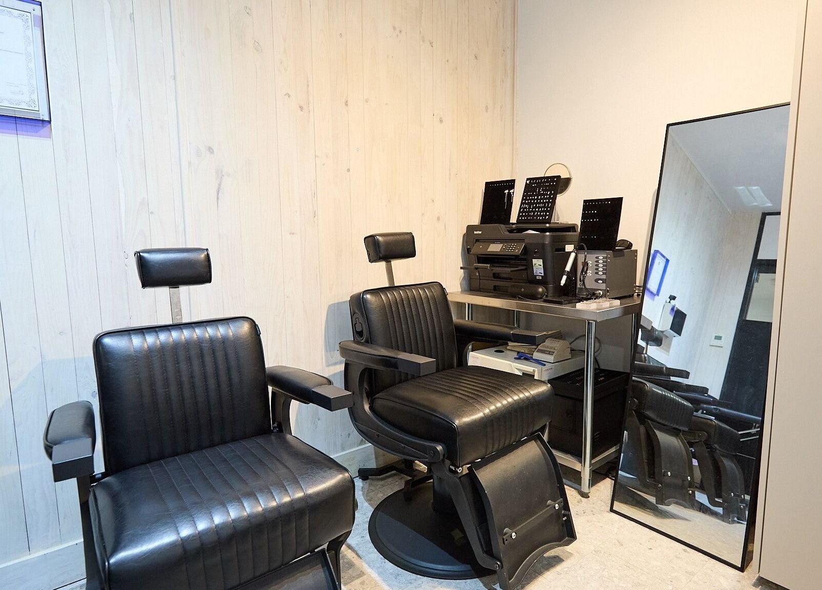 Ouchie salon interior with stylish chairs and mirror in Manly, New South Wales, AU.