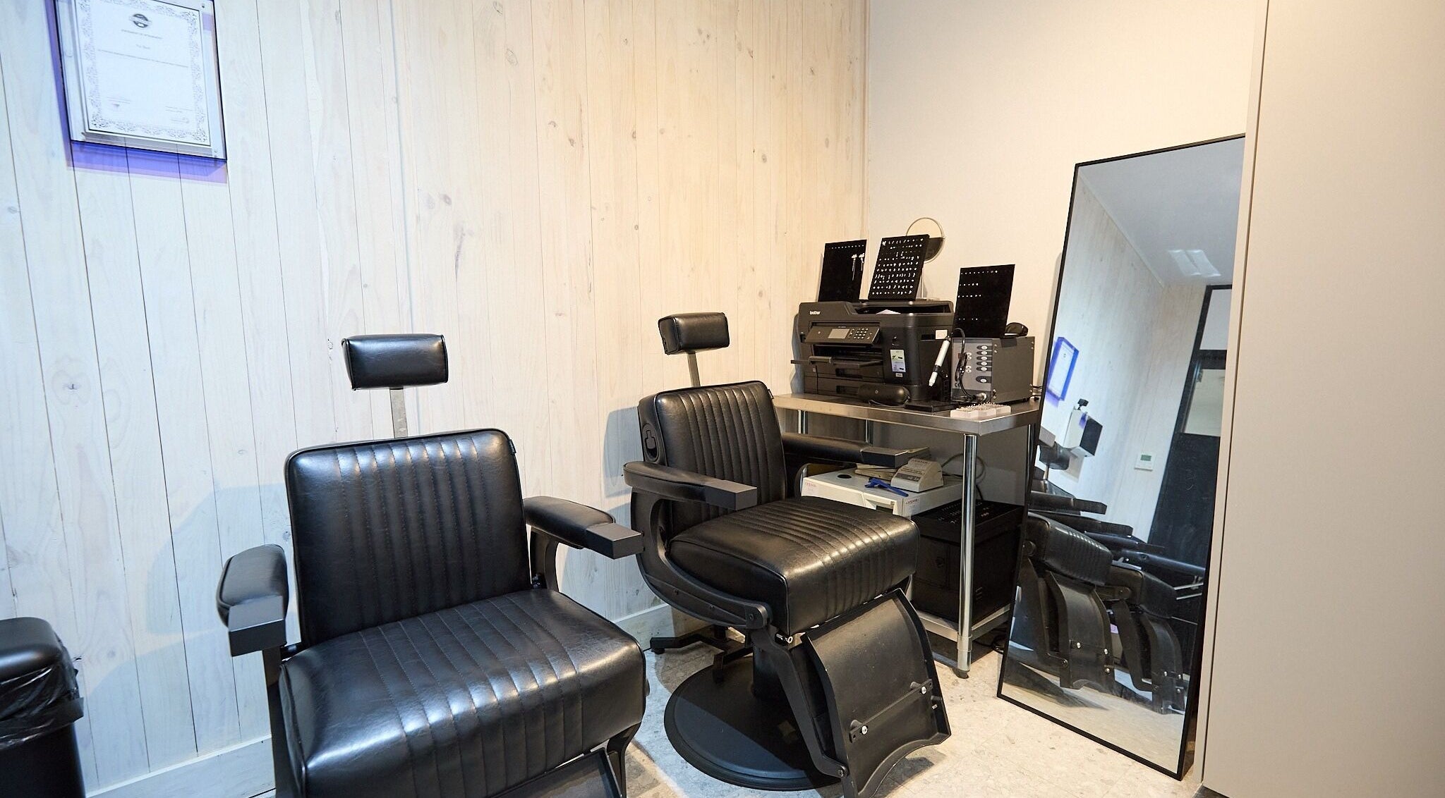 Ouchie salon interior with stylish chairs and mirror in Manly, New South Wales, AU.