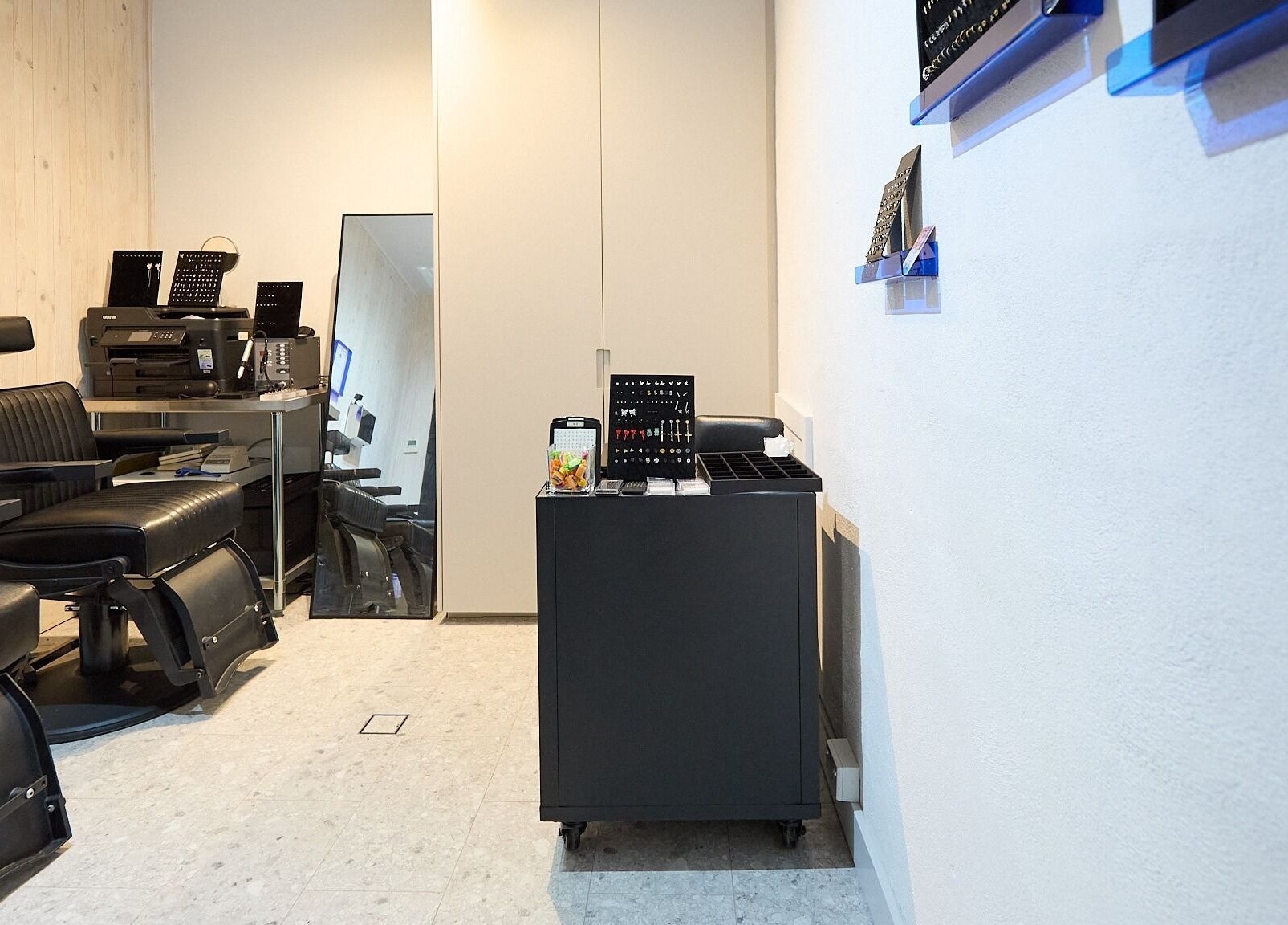 Stylish barber chairs and workstations at Ouchie, Manly, New South Wales, AU, offering premium grooming services.