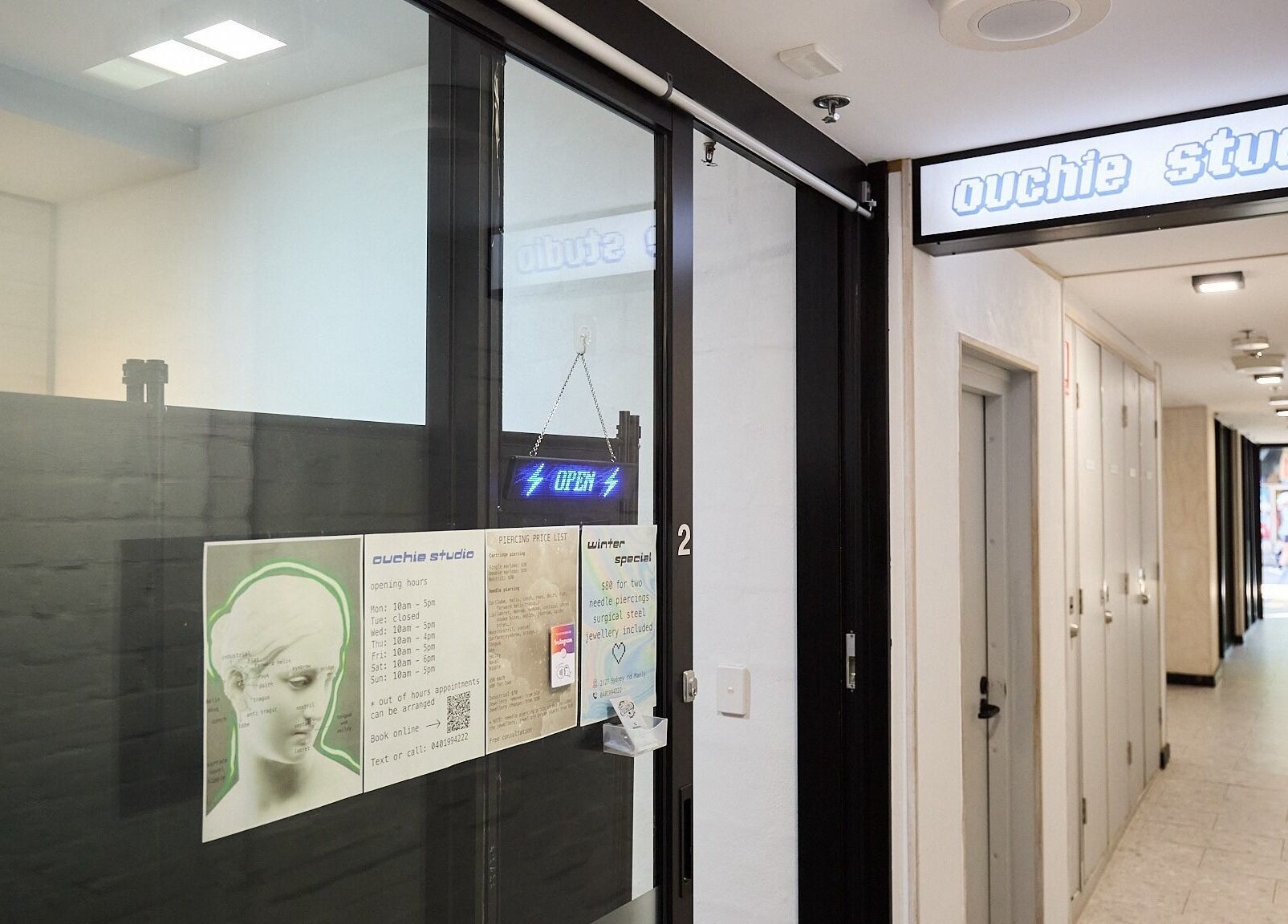 Entrance to Ouchie Studio in Manly, New South Wales, AU with open sign and service details.