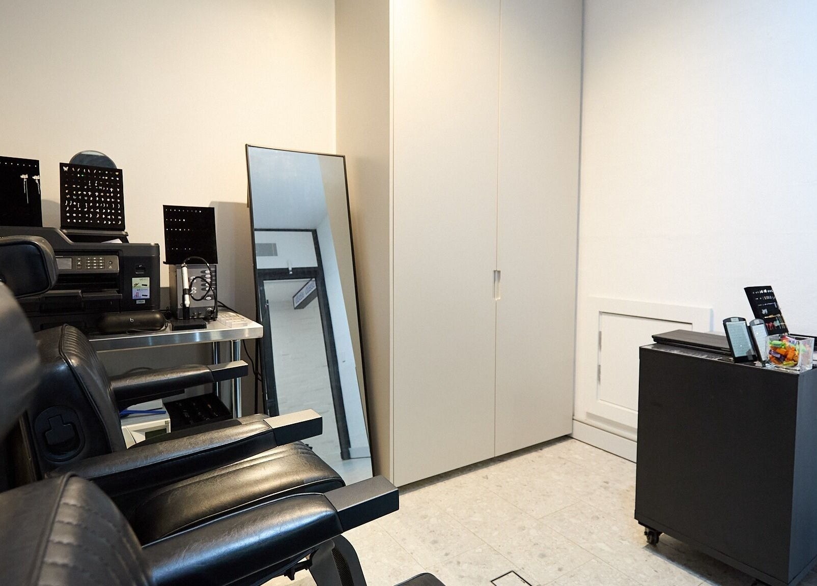 Chic styling area at Ouchie, Manly, New South Wales, AU featuring sleek chairs and a standing mirror.