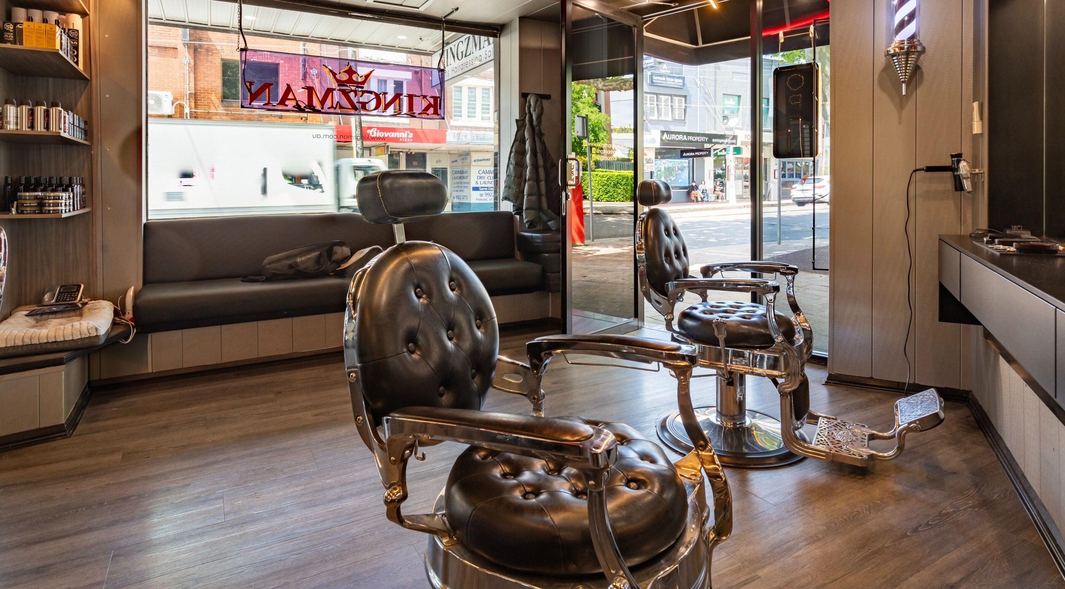 Stylish interior of KINGZMAN barbershop in Cammeray, NSW, AU with vintage chairs and modern decor.