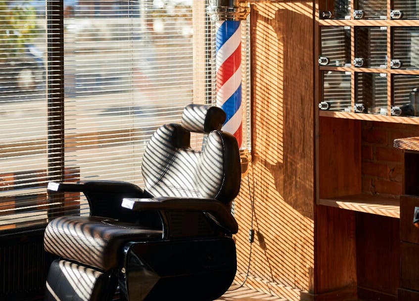 Barber chair in sunlight at KINGZMAN, Cammeray, NSW, AU, creating a serene grooming atmosphere.