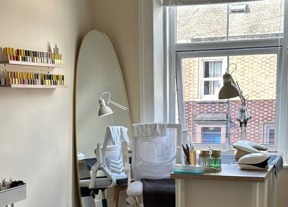 Bright beauty studio at B By Sam, Carlisle, England, GB, featuring a stylish mirror and organized nail polish.