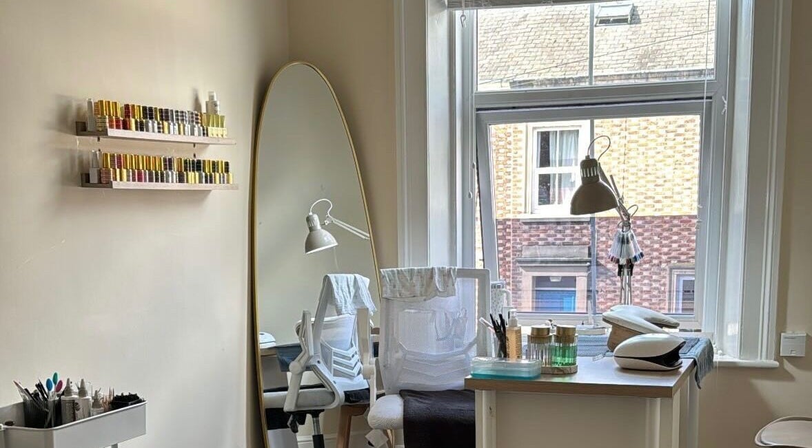Bright beauty studio at B By Sam, Carlisle, England, GB, featuring a stylish mirror and organized nail polish.