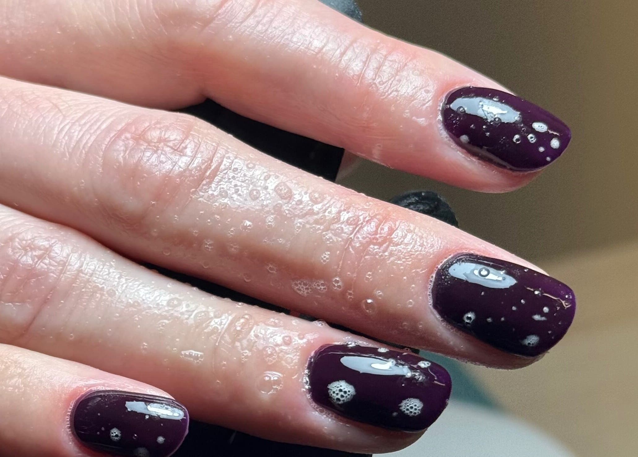 Stylish plum nails at B By Sam in Carlisle, England, GB with glossy finish and water droplets.